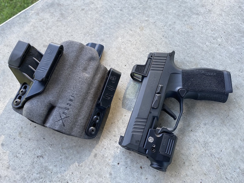 Even small lights, like this Surefire, will extend beyond the muzzle on the P365--and each has to fit in the pocket of the holster. Designing for all of the possibilities is complex.