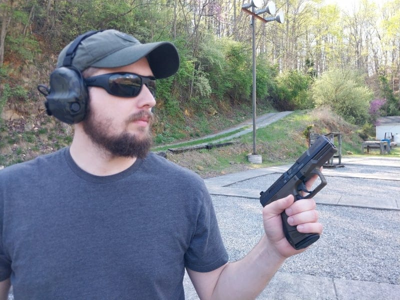 Man holding a semi-automatic pistol